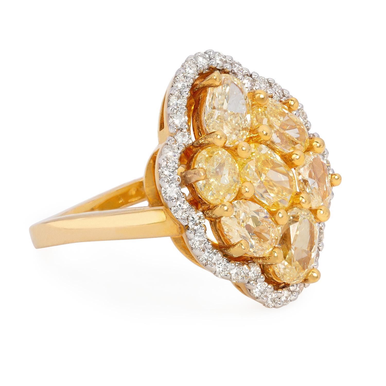 Behold the mesmerizing beauty of this extraordinary ring, where elegance and luxury converge to create a true masterpiece. At its heart lies a captivating centerpiece—a cluster of fancy yellow diamonds, carefully selected to showcase their rich and