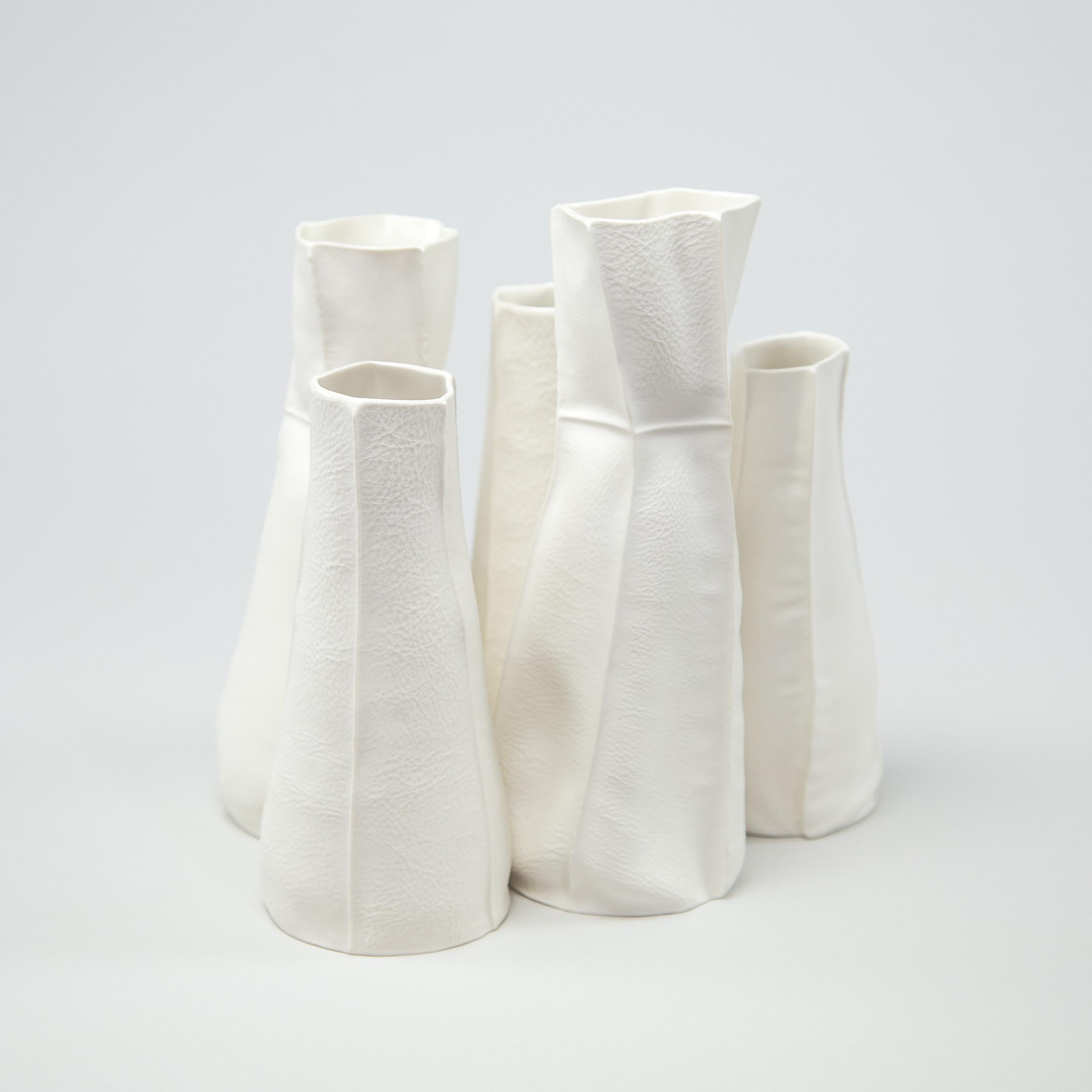 Set of 5 Kawa Vases 04 & 05

Organic white ceramic vases with textured raw porcelain exterior surface and clear glazed interior. As a result of the production process each item is one-of-a-kind.

Cluster of 5 vases consisting of (3) Kawa Vase 04 &