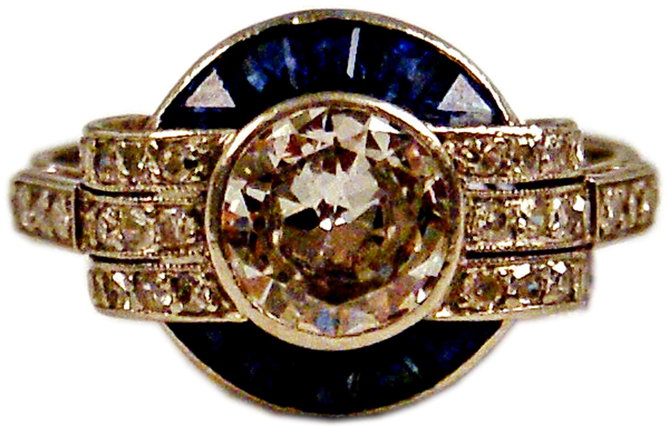 Art Deco Gorgeous Cluster Ring:
PLATINUM  &  ONE LARGE DIAMOND IN MIDDLE AREA  (VINTAGE CUTS / 1.0 Carat)
plus smaller diamonds and sapphires   

Most elegant Art Deco Cluster Ring of French manufactory: 
One large diamond (1.0 Carat) attached to