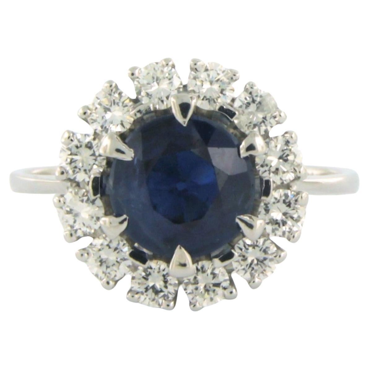 Cluster ring with center stone Sapphire and arround diamonds 18k white gold