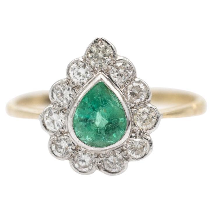 Cluster ring with pear shaped emerald and diamonds, circa 1970s.