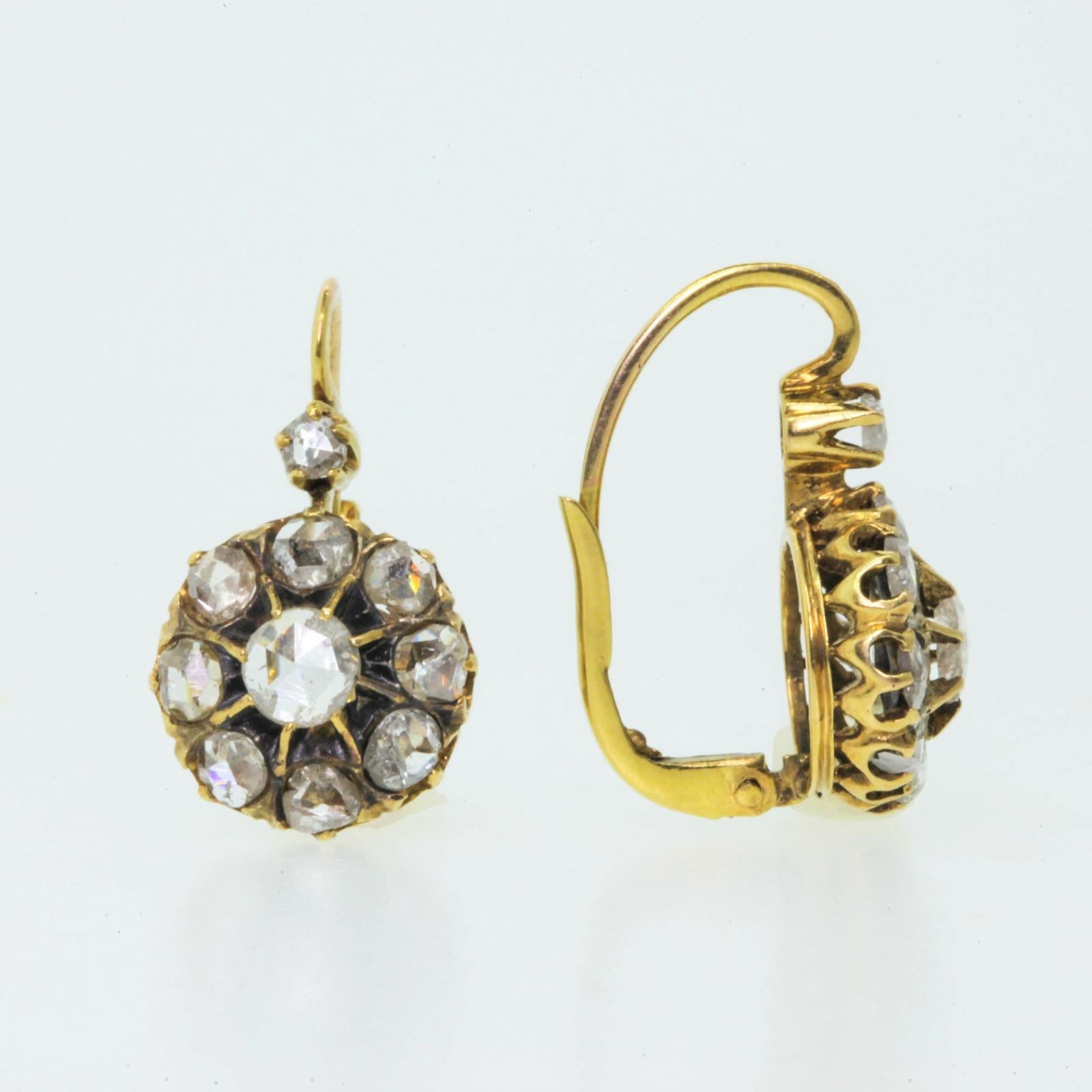 Antique cluster earrings created in 14KT yellow gold and each set with ten old Rose Cut Diamonds.  The diamonds all weigh weigh a total of approx. 1.80 carats of shimmering H/I color - SI/SI clarity.  These easy to wear earrings are completed with