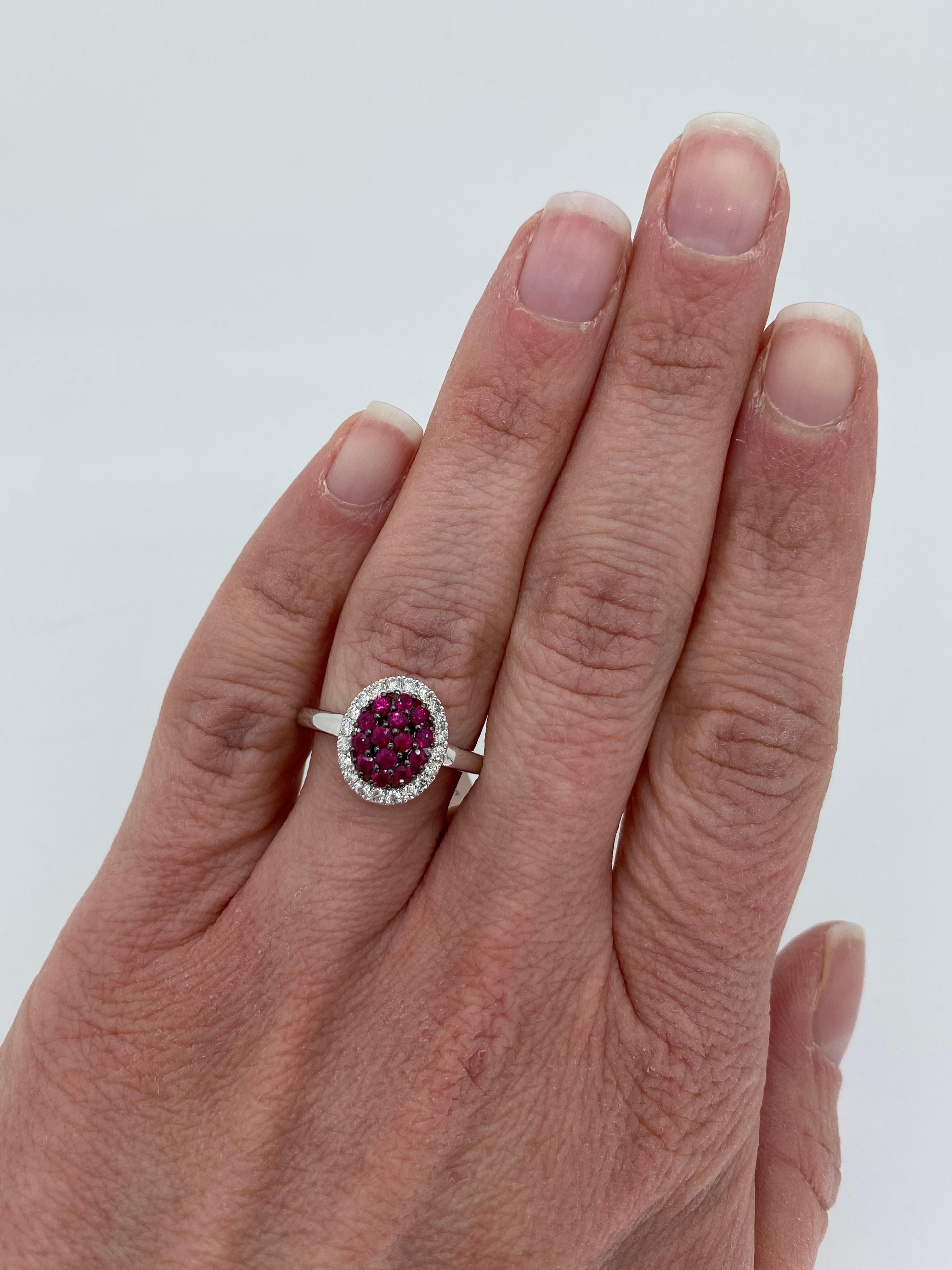 Ruby and diamond cluster ring crafted in 14k white gold with black rhodium accents.

Gemstone: Rubies & Diamonds
Gemstone Carat Weight:  Approximately .50CTW
Diamond Carat Weight:  Approximately .25CTW
Diamond Cut: Round Brilliant Cut
Color: Average
