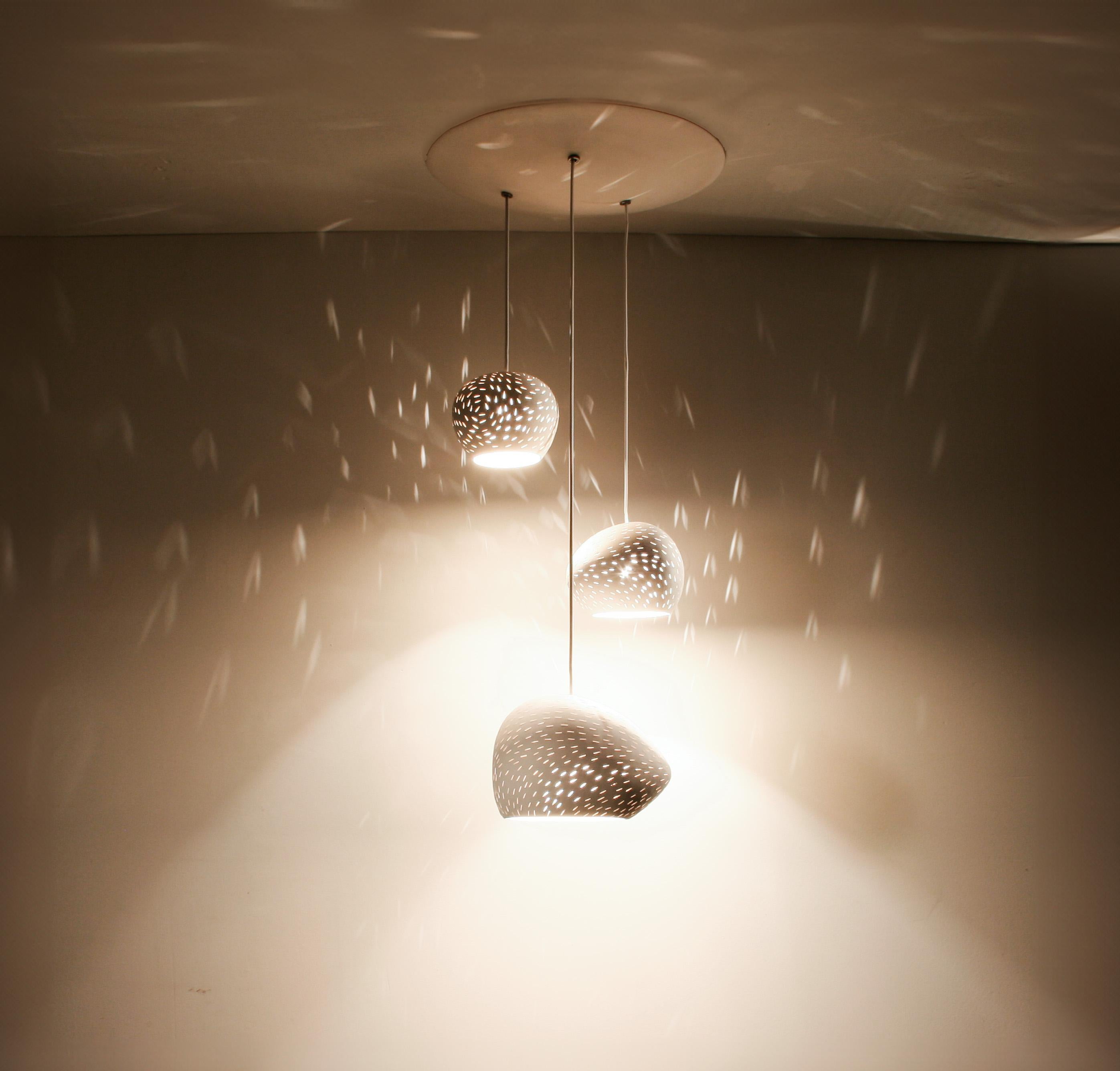 Elevate your space with our stylish and versatile Claylight: CLUSTER 3, triple pendant light. Whether your space is contemporary or modern, maximalist or minimalist, this handcrafted warm white ceramic chandelier is a statement piece that will suit