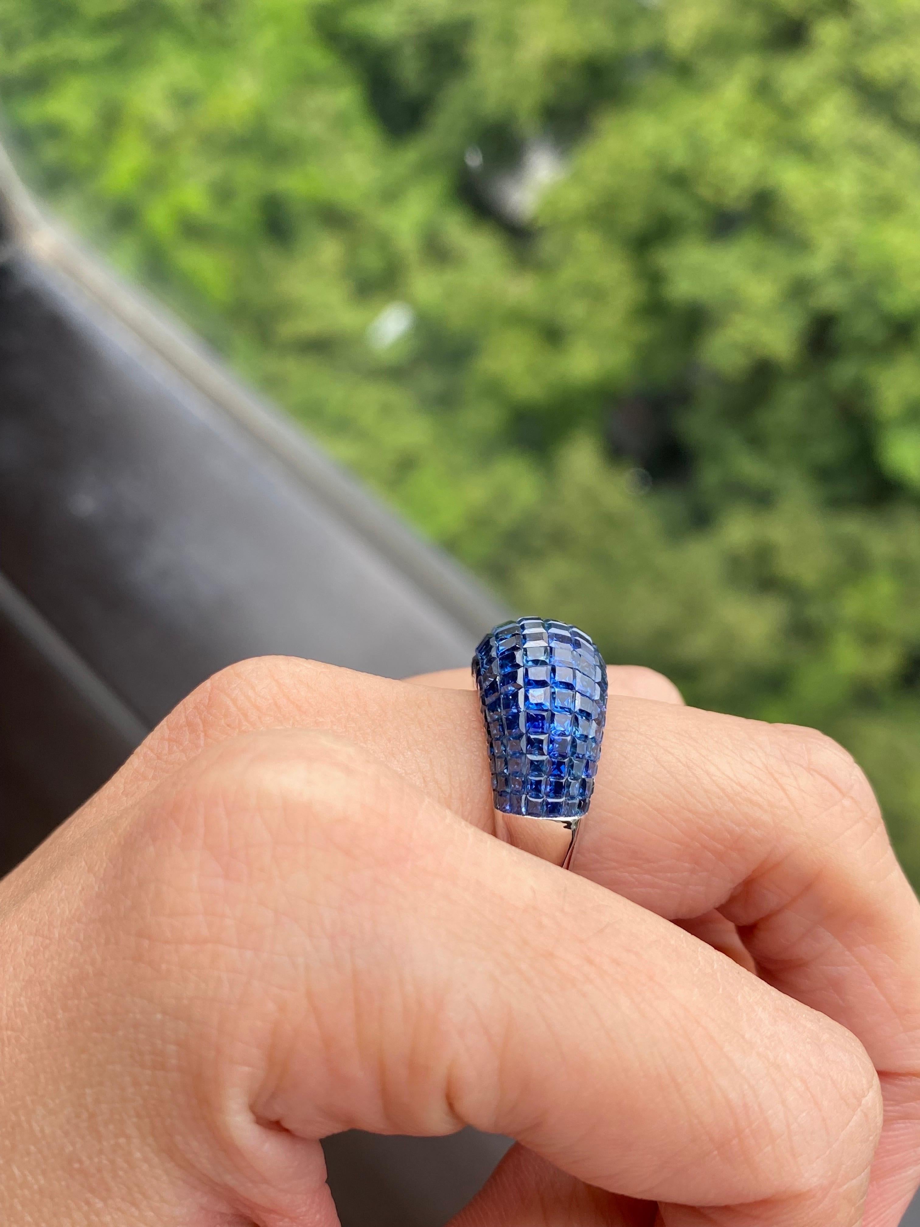 A beautifully hand-crafted 16.63 carat Blue Sapphire cocktail ring, set in solid 18K White Gold. The ring is currently sized at US 6, can be resized. This is an art-deco inspired, invisibly set Sapphire ring with a modern touch.
We provide free