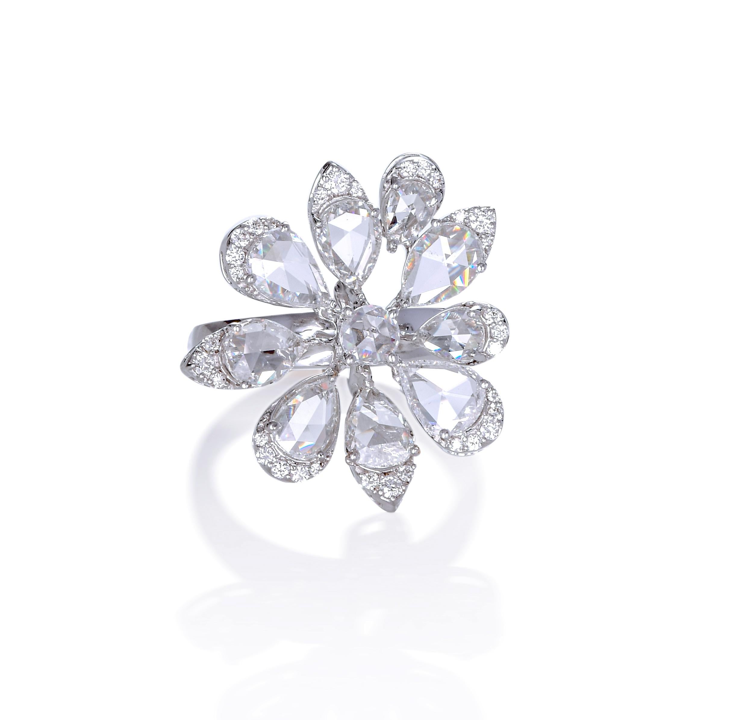A  ring of clustered petals formed with pear-shaped rose cut diamonds and round diamonds in 18k white gold.