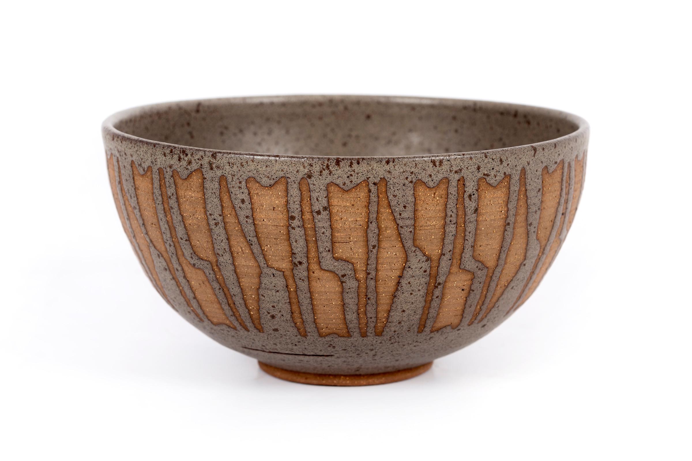 Clyde Burt speckled bowl in glazed and unglazed stoneware with incised, abstract details.
Signed to underside: [CB].
American, circa 1965.