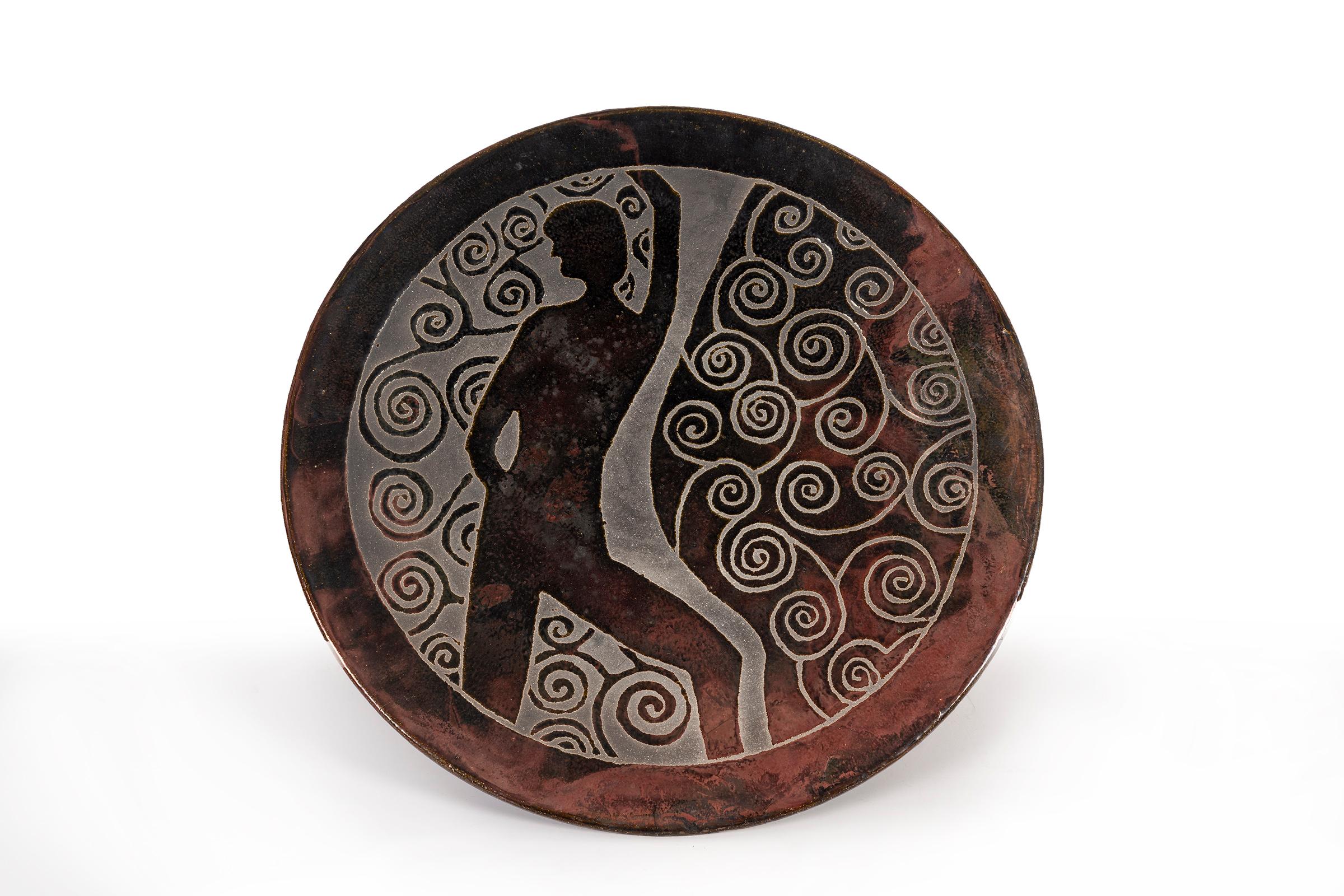 Clyde Burt ceramic charger in glazed stoneware with incised image.
Signature to underside: [CB].
American, circa 1965