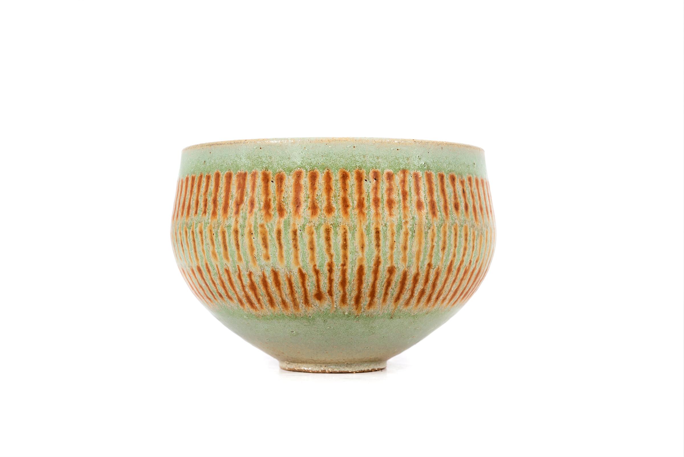 Clyde Burt tea bowl in celadon glazed stoneware with applied abstract details.
Signed to underside: [CB].
American, circa 1965.