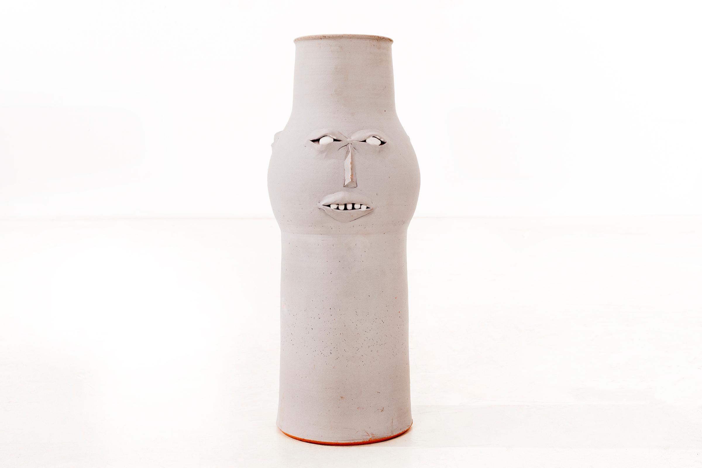 Clyde Burt stylized face vase in matte gray glazed stoneware with manipulated and applied facial details.
Signed to underside: [CB].
American, circa 1965.