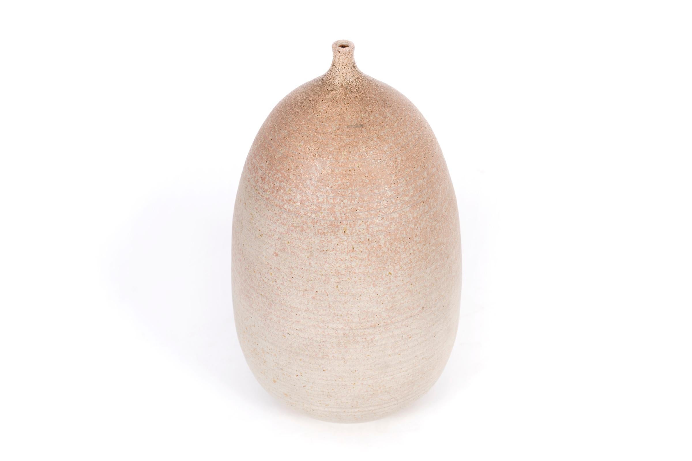 Clyde Burt speckled gourd-form weed vase in blush ombre glazed stoneware.
Signed to underside: [CB].
American, circa 1965.