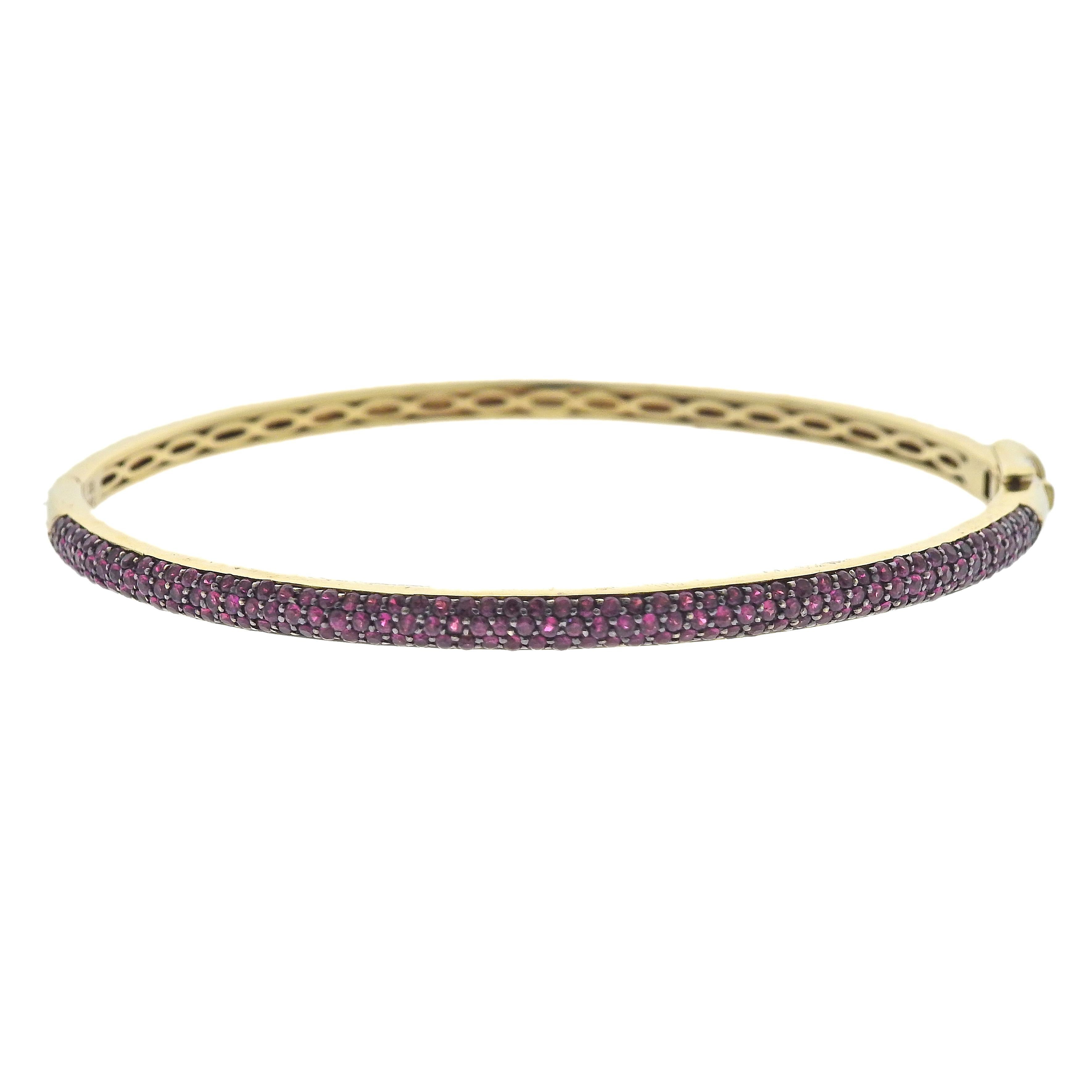 Clyde Duneier Gold Ruby Bangle Bracelet. Features approx 1.80ctw in Rubies. Bracelet will fit 6 3/4