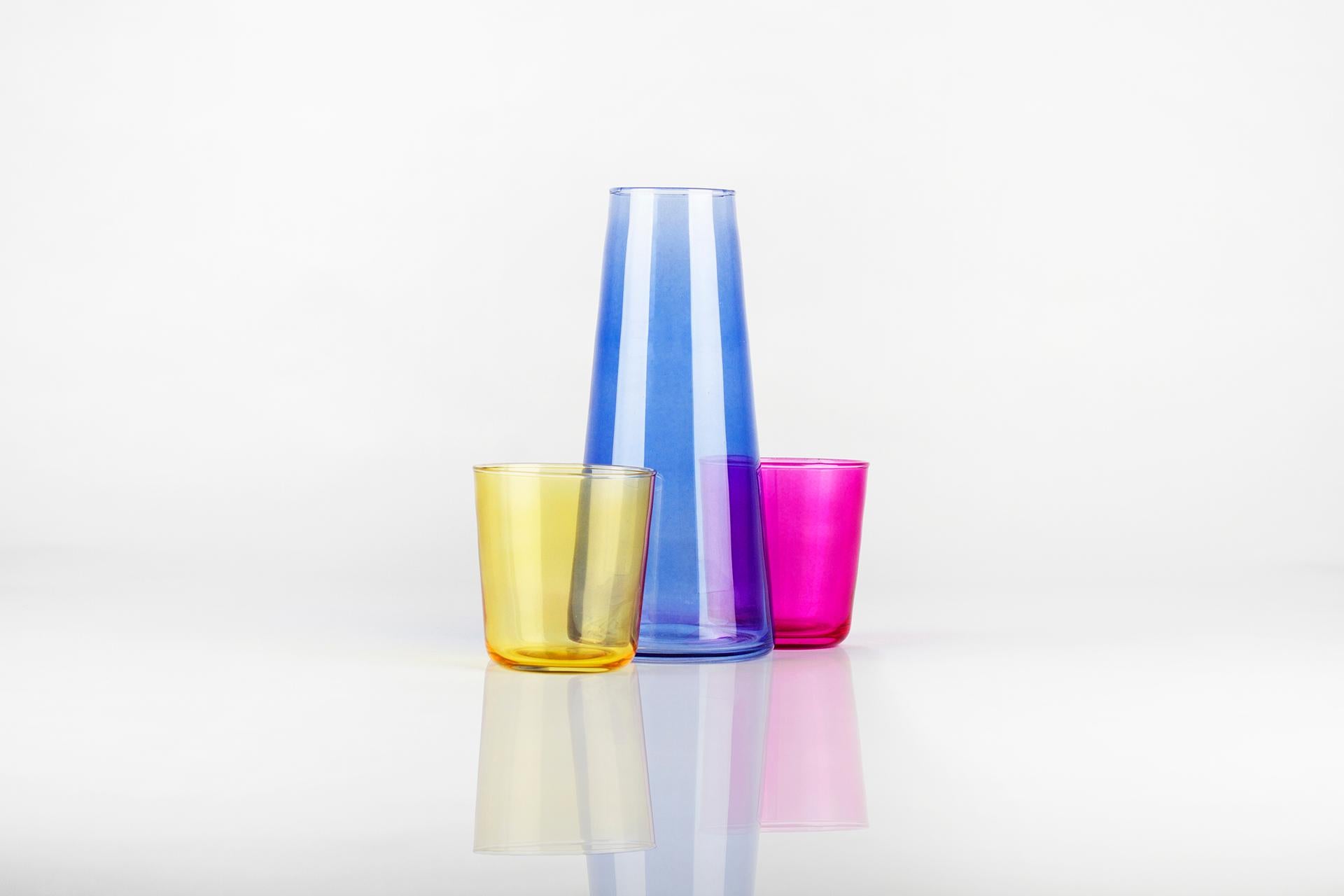CMYK is a carafe and glass set, made for VICARA. Designed by Ojeam Studio and handmade in Portugal, this set is an original way to serve water by the bedside, or to present it on a coffee or cocktail table. Also perfect to have on a counter, this