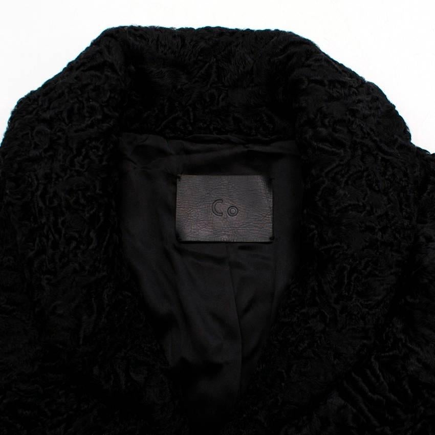 Dyed Persian lamb black textured cape with a collar and hook fastenings. 
Measurements are taken laying flat, seam to seam. 

Shoulders: 45cm Length: 78cm
