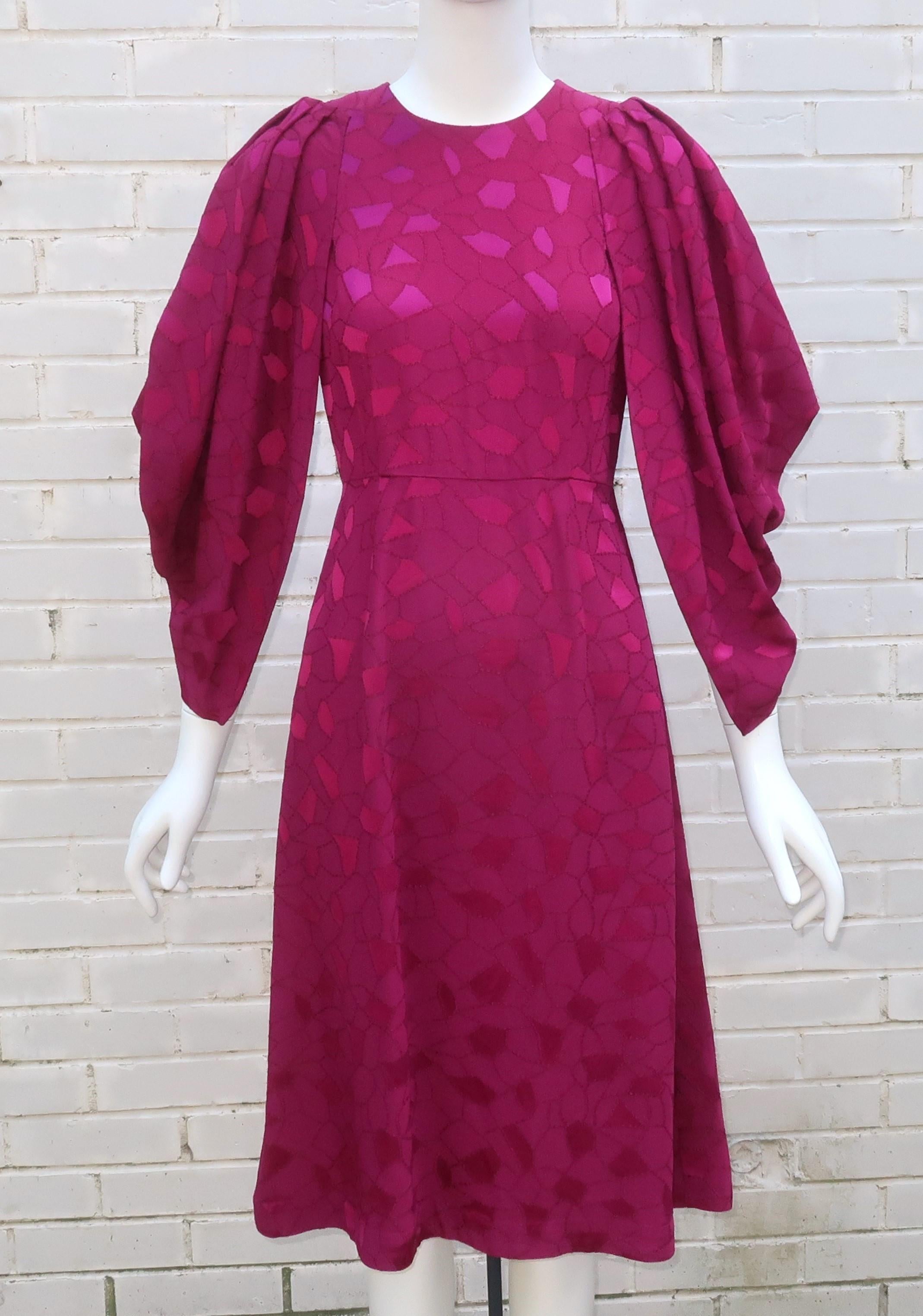 Gorgeous cocoon sleeved magenta dress by CO, a Los Angeles based brand.  The magenta fabric is a viscose and acetate blend with a weighty crepe feel and a look that is reminiscent of jacquard.  The dress zips and hooks at the back with a fitted