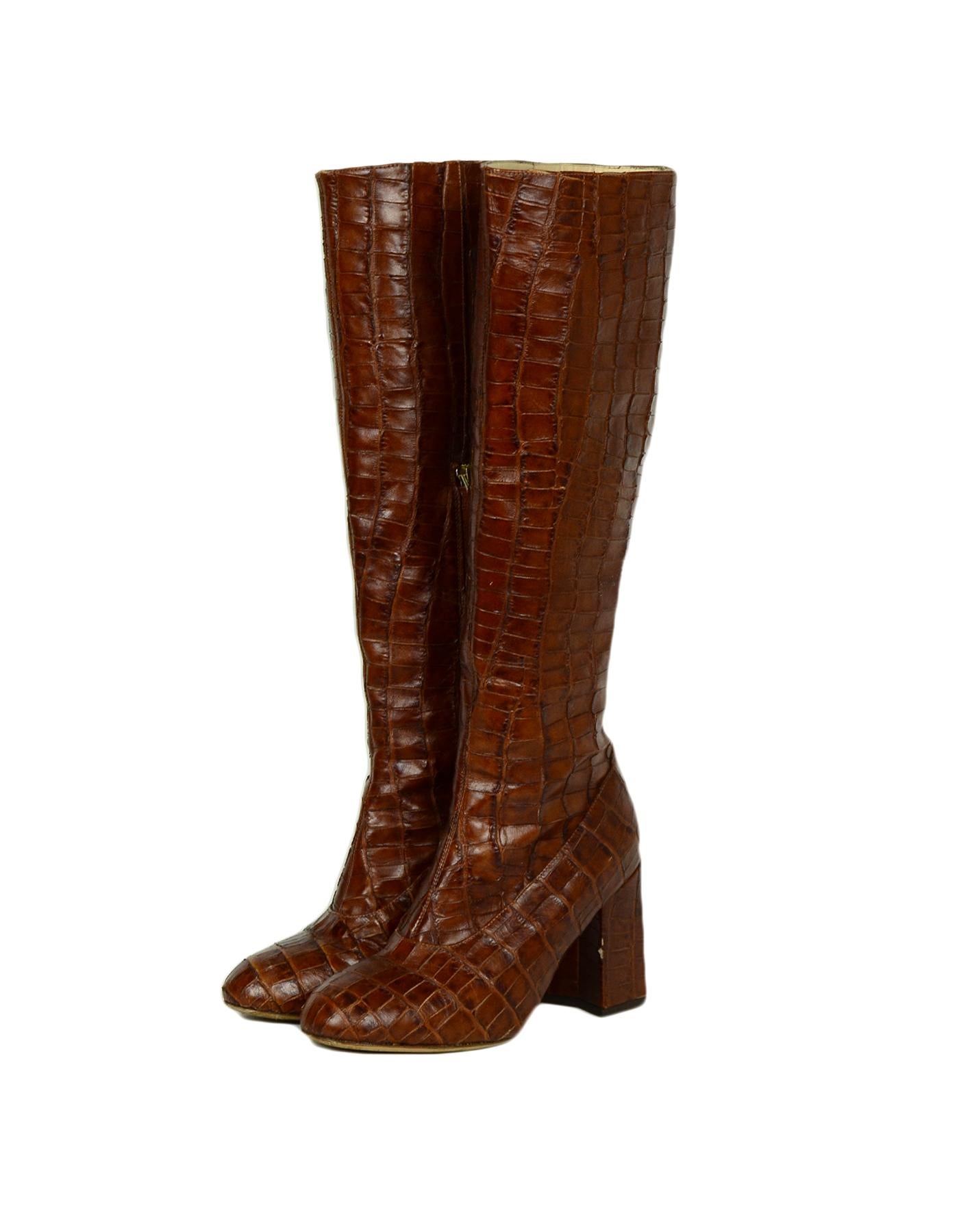 Co. Cognac Embossed Crocodile Print Boots sz 37

Made In: Italy 
Color: Cognac, Brown
Hardware: Silvertone
Materials: Crocodile
Closure/Opening: Slip on
Overall Condition:  Good pre-owned condition, wear on the soles, the insoles, and the tips.