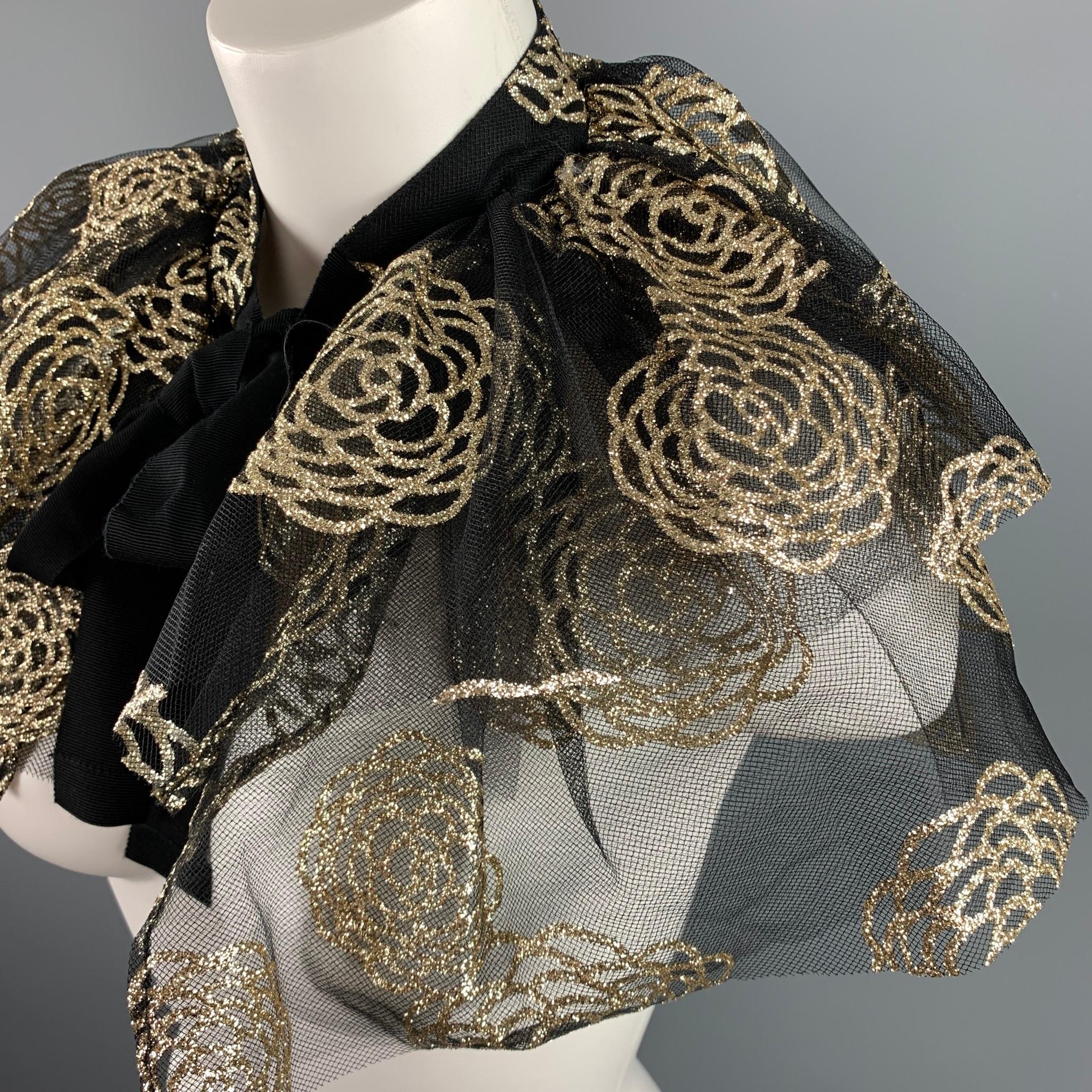 CO collar comes in a black & gold metallic floral tule featuring a ribbon tie closure. 

Excellent Pre-Owned Condition.
Marked: One Size