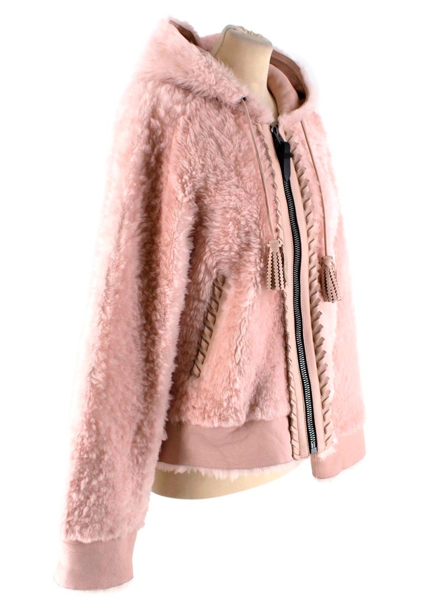 Coach Baby Pink Shearling Leather Zipped Jacket

- Baby pink shearling and leather jacket 
- Leather inner lining 
- Shearling outer 
- Zipped front fastening 
- Hooded with leather tassels
- Braided leather trim detailing
- Side pockets