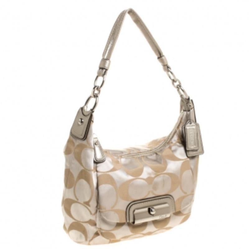 Well known for their contemporary designs, Coach handbags are at the top of every woman's wardrobe. Every fashion connoisseur needs a beige & gold handbag just like this one. Designed with canvas and leather, this bag will look trendy as ever, every