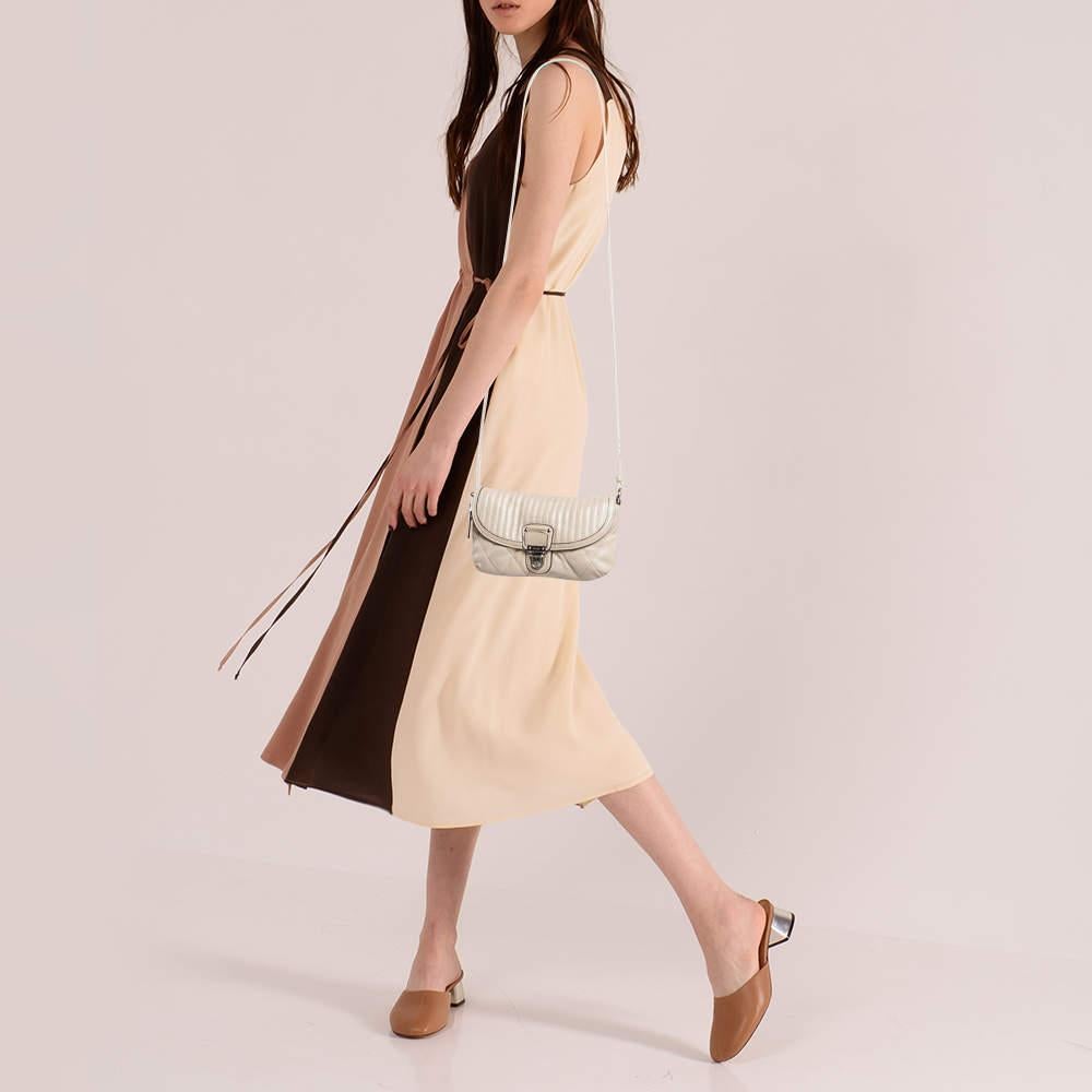 Structured sophisticated and stylish are some words that describe this crossbody bag Crafted from best quality material the creation is adorned with the labels signature appeal held by comfortable handles and equipped with a well spaced interior.