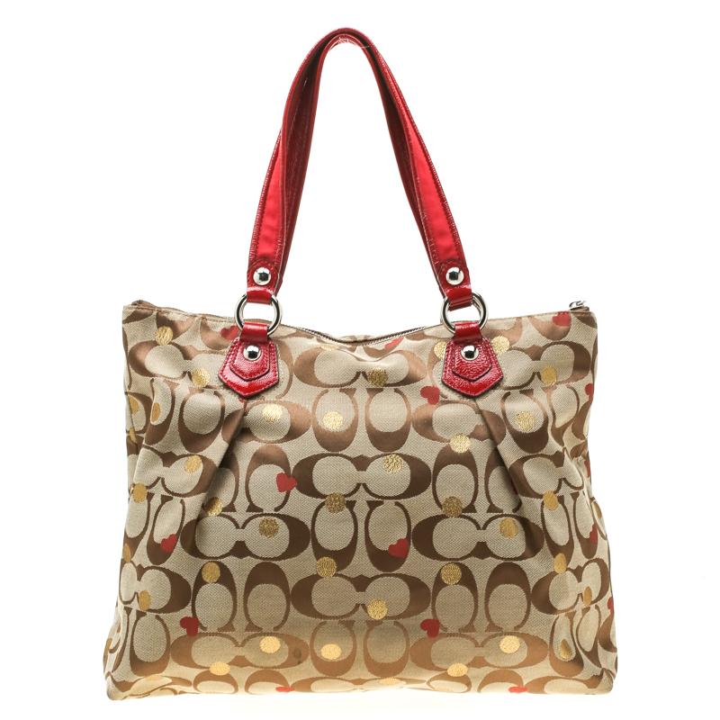 This Poppy Laura Secret Admirer tote from Coach is crafted signature coated canvas and has a zip detail at the front along with the brand logo plaque and two top handles. The zip closure at the top opens to a nylon-lined interior featuring a slip