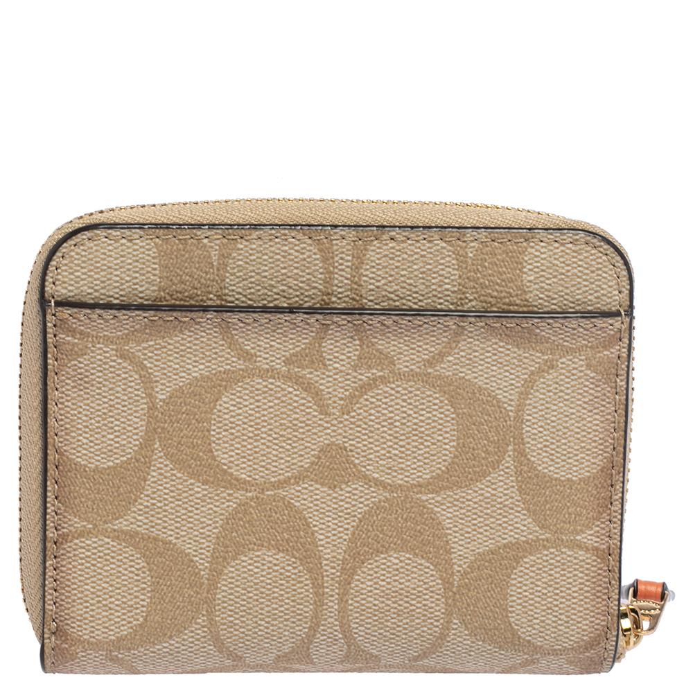 Stylish wallets are a closet must-have! Crafted from signature canvas, this beige wallet is a Coach creation. The wallet is lined with nylon on the insides and flaunts a pretty strawberry applique at the front.

Includes: Info Booklet
