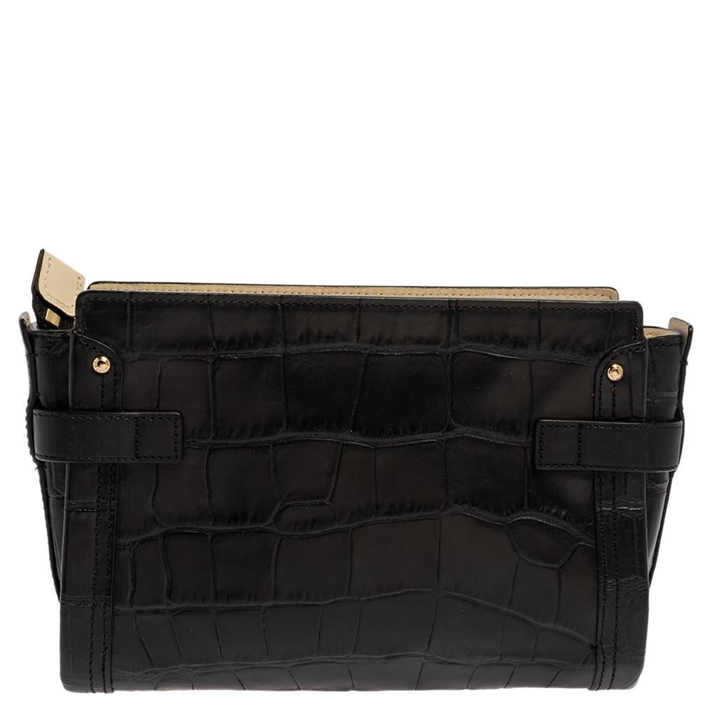 Crafted from croc-embossed leather, this Coach bag is stylish and functional. It carries a black exterior and a top zipper that leads way to a fabric compartment sized to carry your essentials. The bag is equipped with a removable shoulder strap and