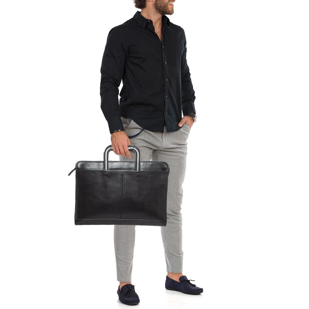 Marked by flawless craftsmanship and enduring appeal, this Coach briefcase is bound to be a versatile and durable accessory. It has a spacious size.