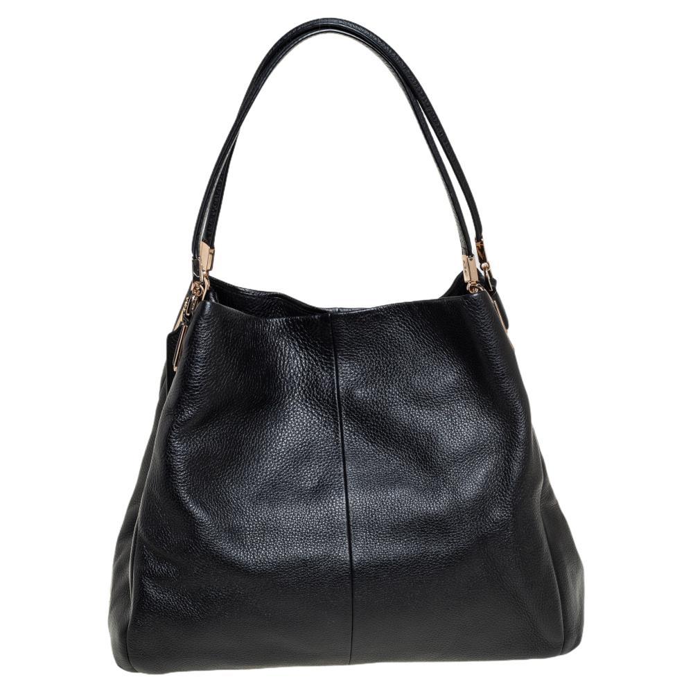 Grab this stylish shoulder bag from Coach to style your everyday looks effortlessly. Crafted from quality leather, this Edie bag comes in black. It is styled with dual handles, a brand logo in the front, a nylon interior with a zip compartment, and