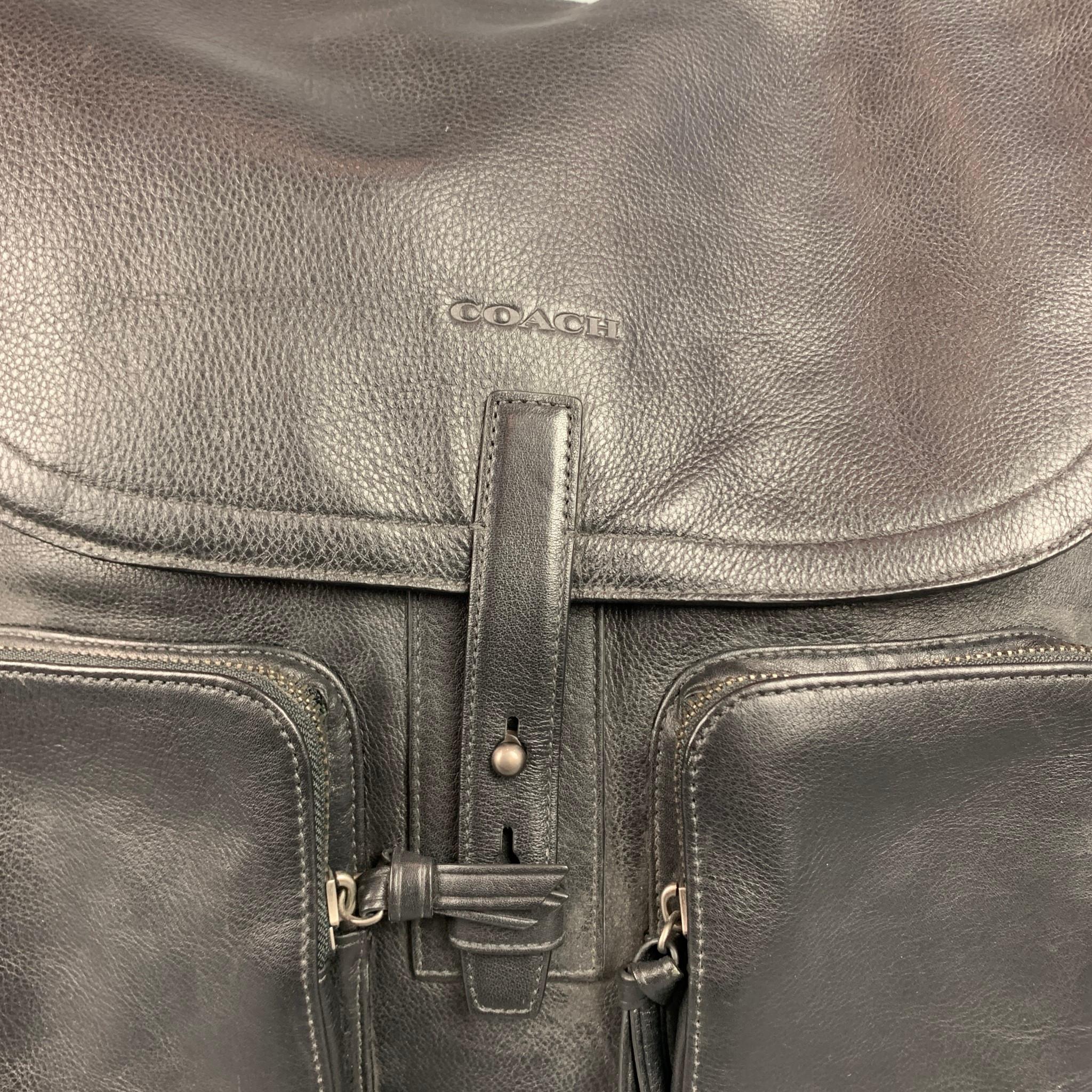 COACH backpack comes in a black leather featuring a top handle, umbrella strap, front pockets, logo tags, and inner pockets.

Very Good Pre-Owned Condition.

Measurements:

Length: 12.5 in.
Width: 4 in.
Height: 14 in.
Drop: 2.5 in. 