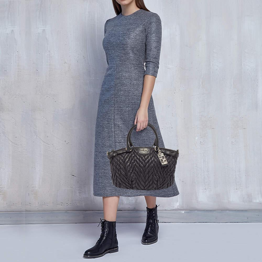 This Madison satchel was made to commemorate the 70th anniversary of Coach. It comes made from fine materials and is designed with leather trims two handles a Coach metal tag and a spacious satin interior to house your essentials with ease.