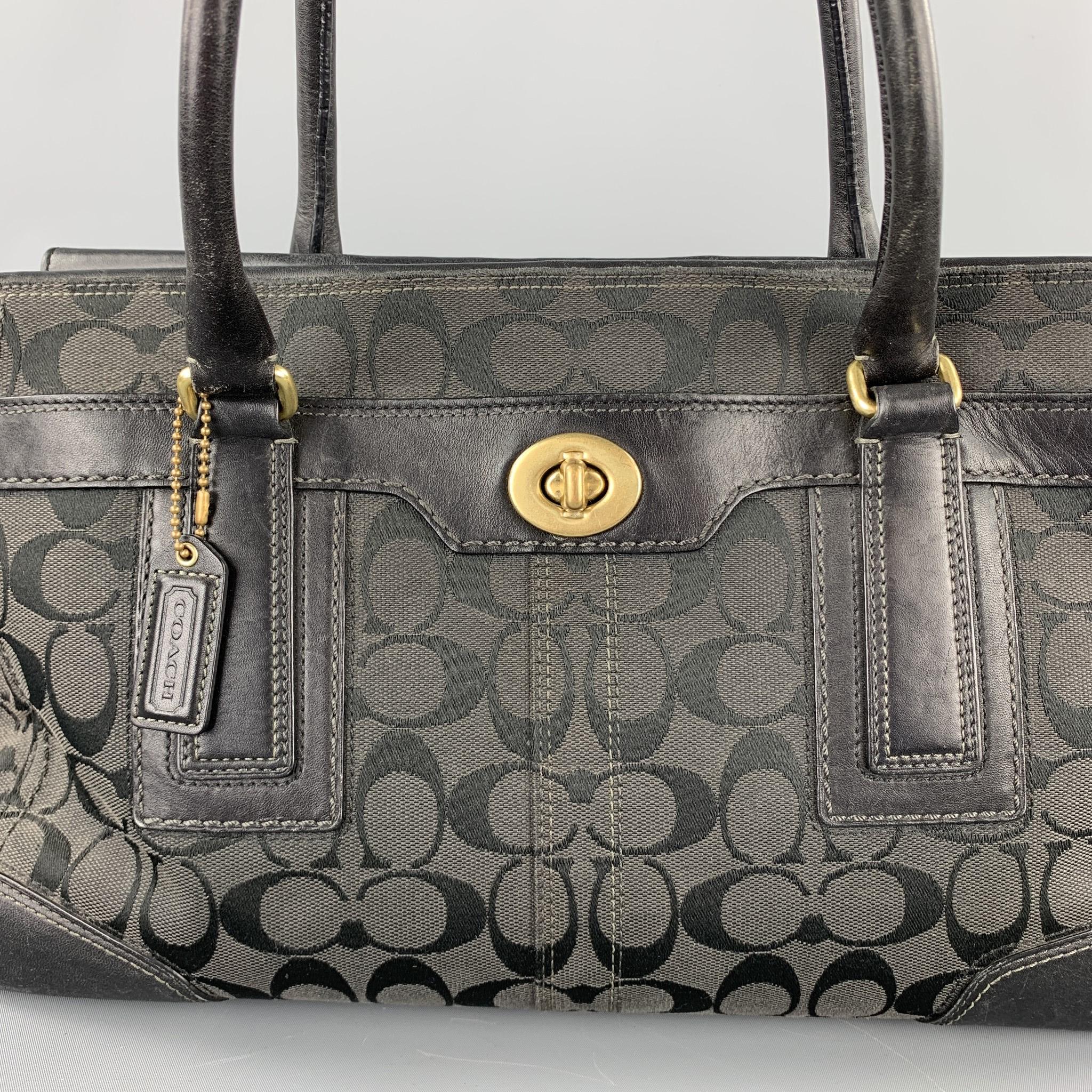 COACH handbag comes in a black monogram canvas with a leather trim featuring top handles, gold tone hardware, one inner pocket, and a zip up closure. Includes matching wallet.

Good Pre-Owned Condition.

Measurements:

Length: 14 in.
Width: 5 in.