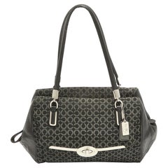 Cartera Madeline Madison de tela y piel negra Op Art de Coach