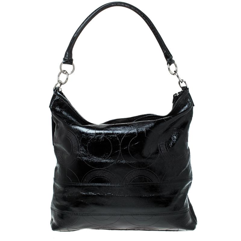 Coach brings to you this stylish and trendy handbag. Crafted in patent leather, this bag is sure to make an amazing style statement. Lined with the best fabric, this bag comes with a single handle and a shoulder strap. The black bag has ample space