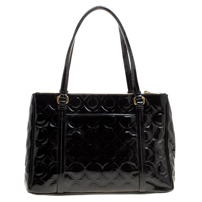Beautifully handcrafted, this Coach satchel is stylish and functional. It has been crafted from embossed black leather and equipped with a fabric interior and two handles.

Includes: Original Dustbag