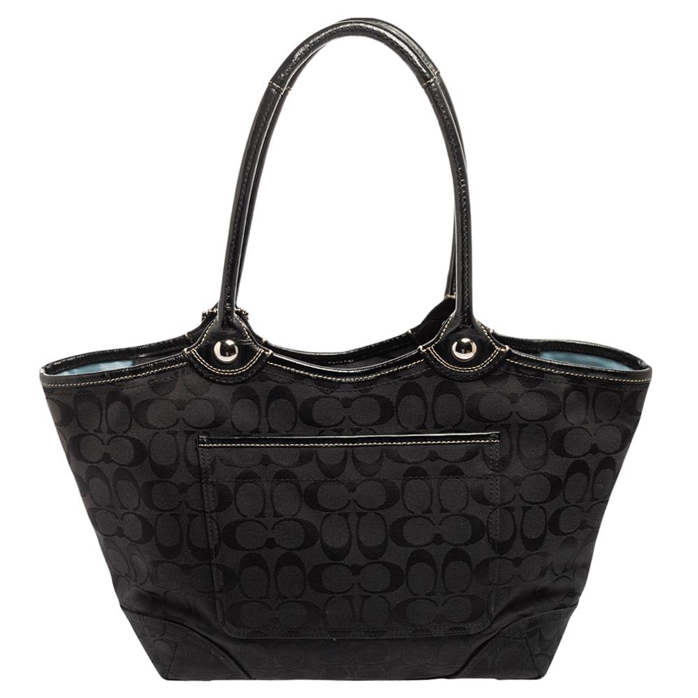 Upgrade your bag collection with this amazing tote from Coach. It has been crafted from coated canvas and leather and flaunts an elegant black hue with silver-tone hardware. It is finished with dual handles and a capacious interior that can house