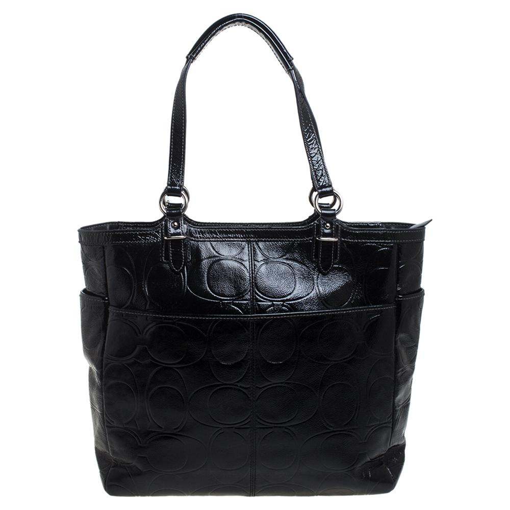 This spectacular tote from Coach is perfect for work days as well as for a casual day out with friends. Crafted from signature embossed patent leather, the tote carries two top handles and a logo plaque on the front. A spacious interior lined with