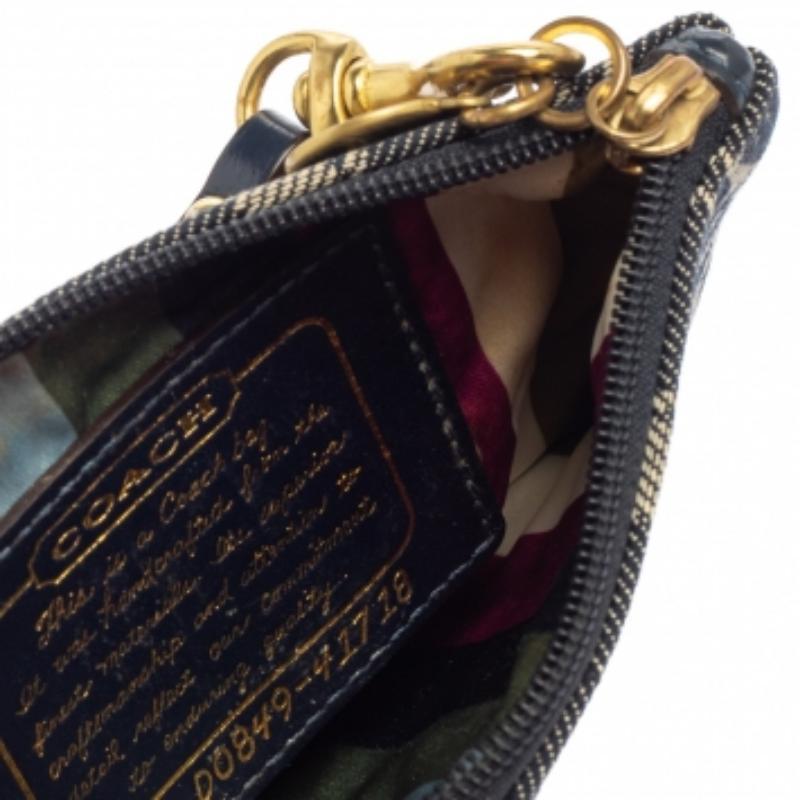 A trendy clutch like this one from Coach will be excellent to hold your little essentials. It is crafted from signature canvas & patent leather in an impressive blue shade, lined with fabric, and comes with a wristlet zip closure. Carry it around