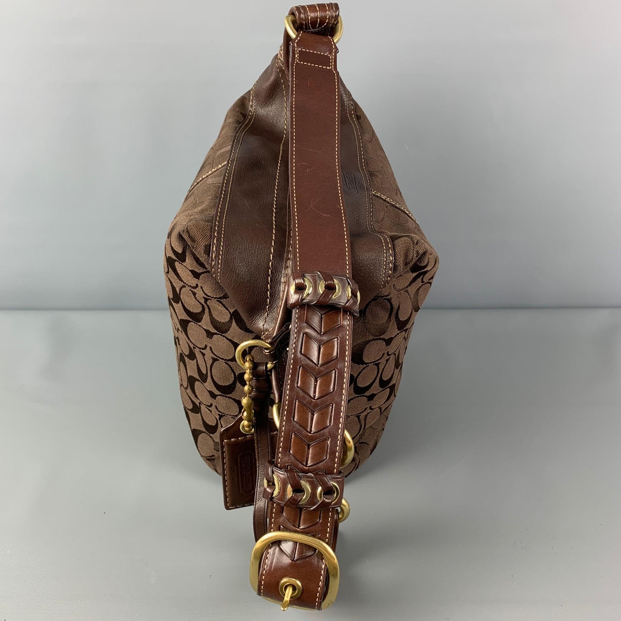 COACH bag comes in a brown monogram print canvas featuring a adjustable braided shoulder strap, gold tone hardware, contrast stitching, inner pocket, and a top zipper closure. Very Good
Pre-Owned Condition. Light wear. As-is. 

Marked:   F0768-11438