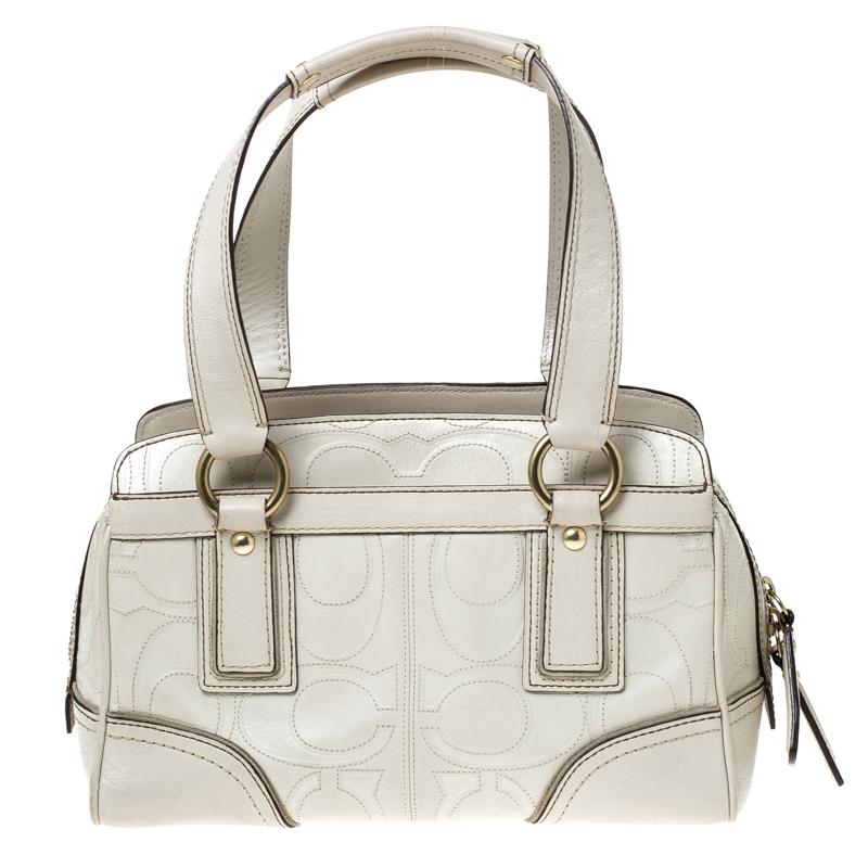 Be the talk of the town when you carry this Coach handbag. Crafted with leather, this bag is styled with monogram stitch detailing all over, a turnlock secured pocket to the front and twin top handles. This chic bag has an equally divine interior