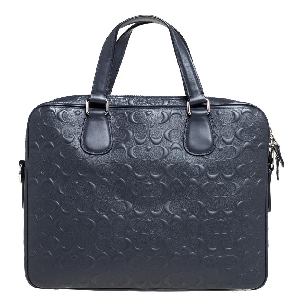 Crafted from coated canvas and leather, this laptop bag by Coach features two top handles and a detachable shoulder strap. It has a front zip pocket and the fabric interior is perfectly sized to carry your laptop and other essentials.

Includes: