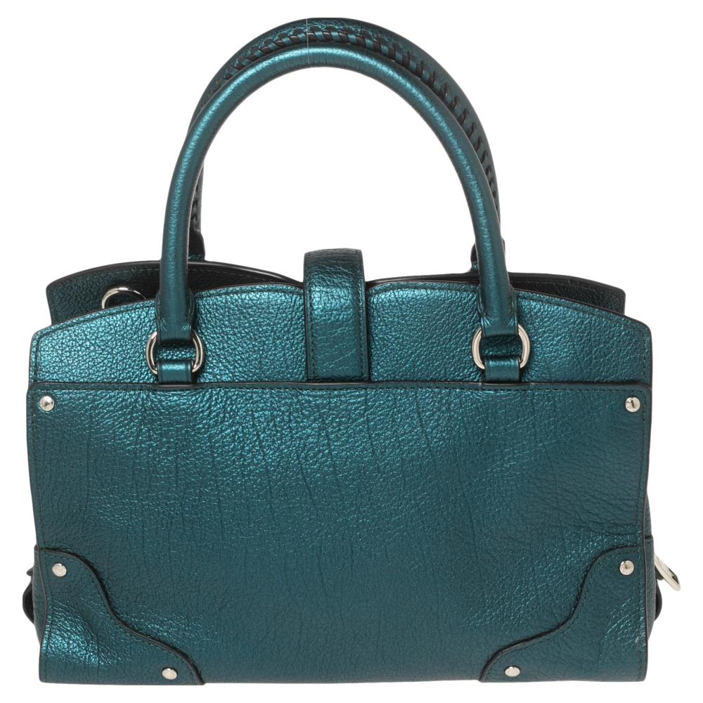 Made from dark emerald leather, this Coach satchel brings a convenient size and a refined appeal. It features embellishments, two handles, a detachable strap, silver-tone hardware, and a fabric-lined interior.

Includes: Original Dustbag, Info