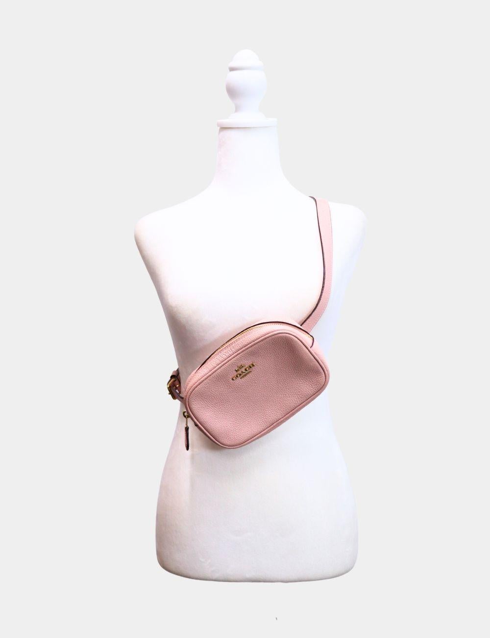 Coach Pink Pebbled Leather Belt Bag with Gold Logo

Keep your essentials close in style with this Coach pink leather belt bag, crafted from soft pebbled leather and finished with the brand’s iconic gold logo. Compact and functional, this hands-free