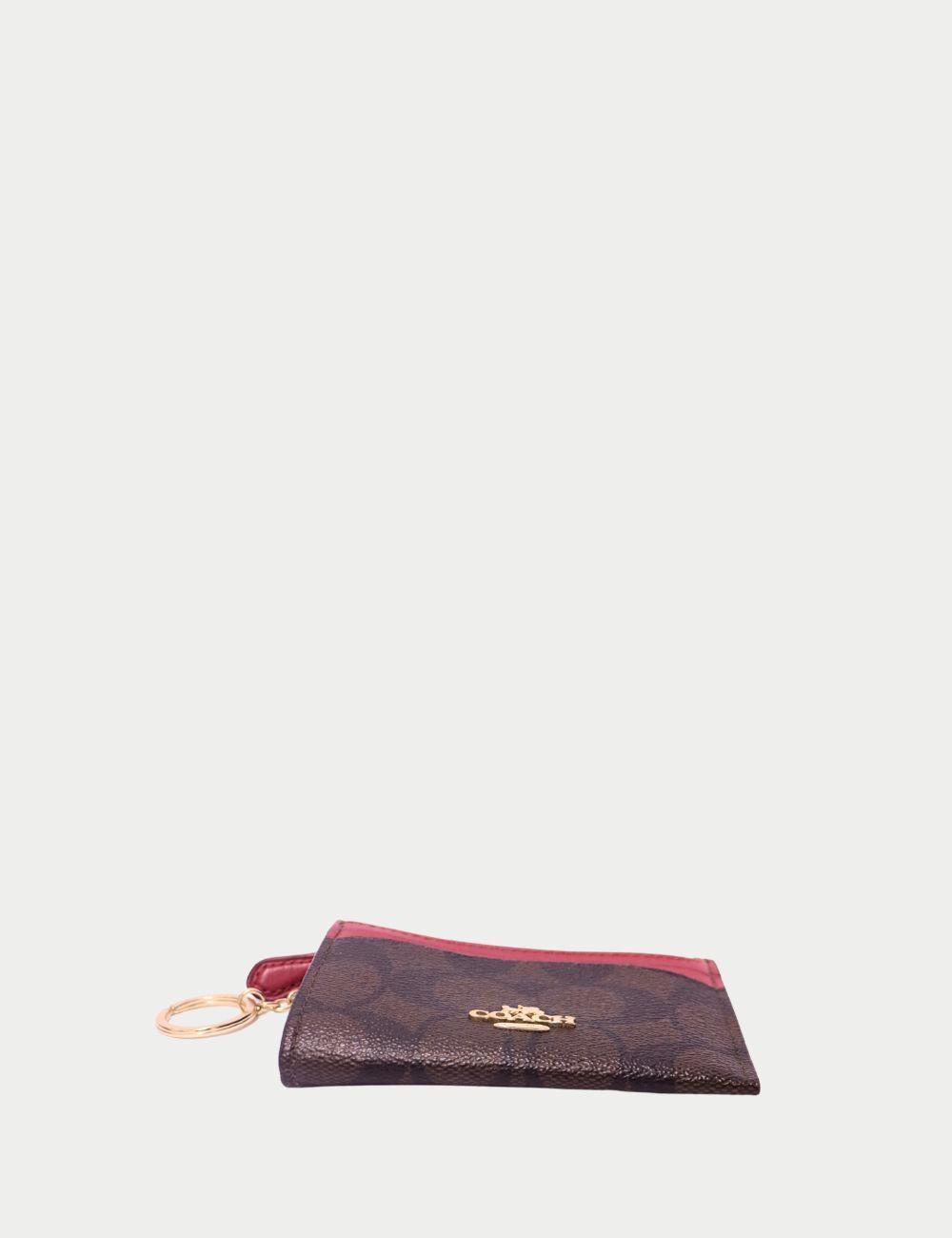 Coach Signature Canvas & Red Leather Card Case with Key Ring


Add a pop of color to your essentials with the Coach Signature Canvas & Red Leather Card Case, a compact yet functional accessory perfect for everyday use. Crafted from the brand’s