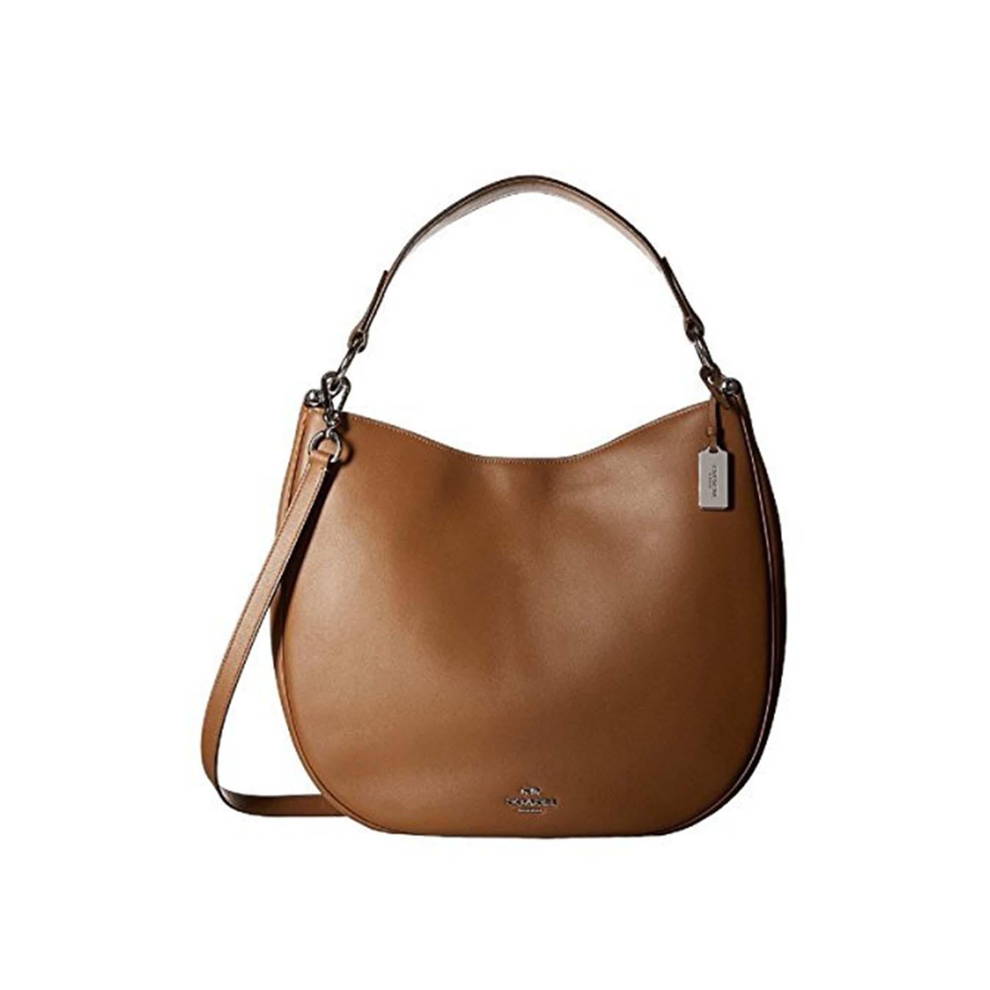 Comes without dust bag. Saddle color. Silver tone hardware. 100% Genuine Leather. Chic and slouchy in supple glove-tanned leather, this graceful silhouette is finished with dressy hardware and an adjustable strap for multiple wearing options. Zip