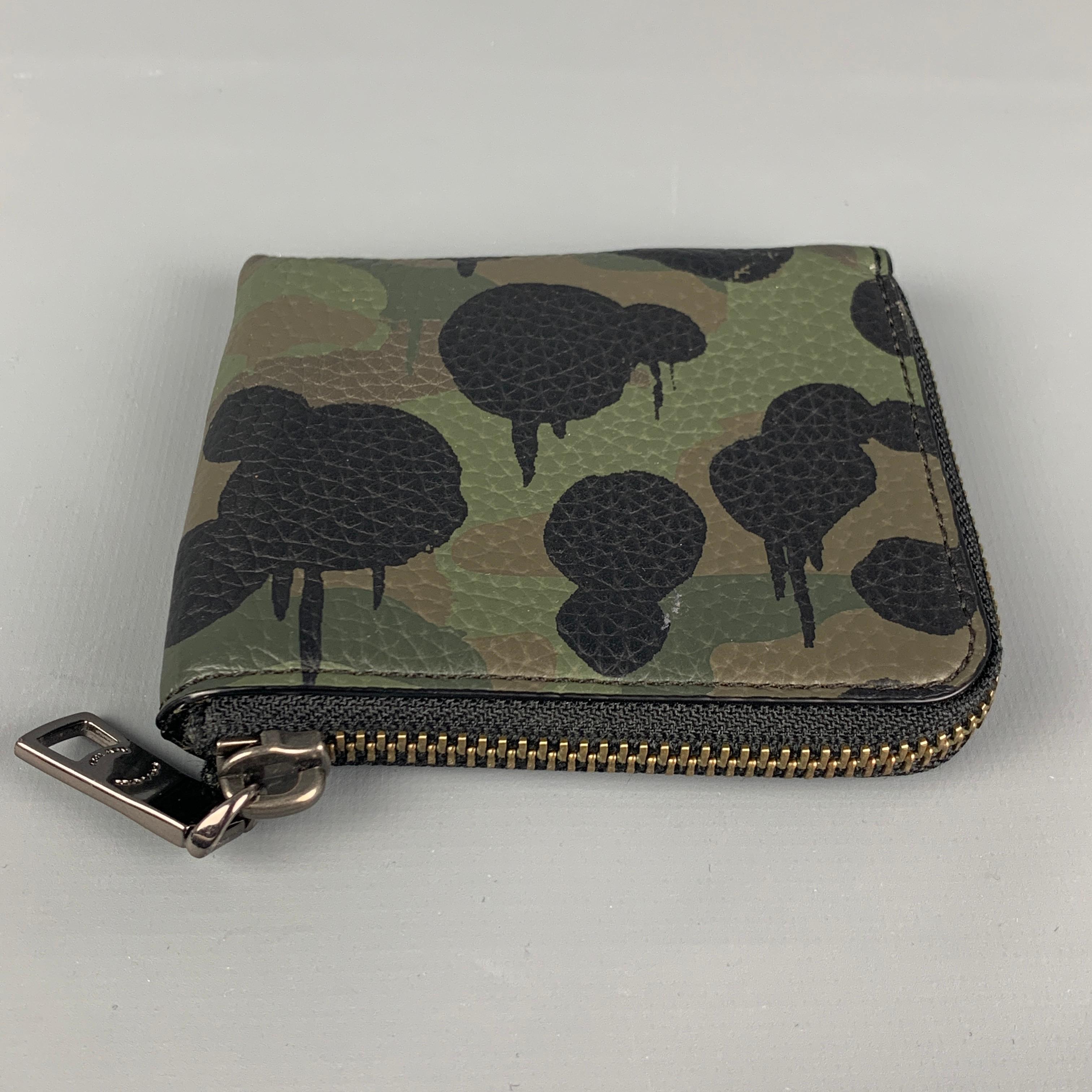 COACH wallet comes in a green & black pebble grain camouflage leather featuring inner slots and  zipper closure. Comes with dust bag. 

Very Good Pre-Owned Condition.

Measurements:

Length: 4 in.
Height: 3.5 in. 