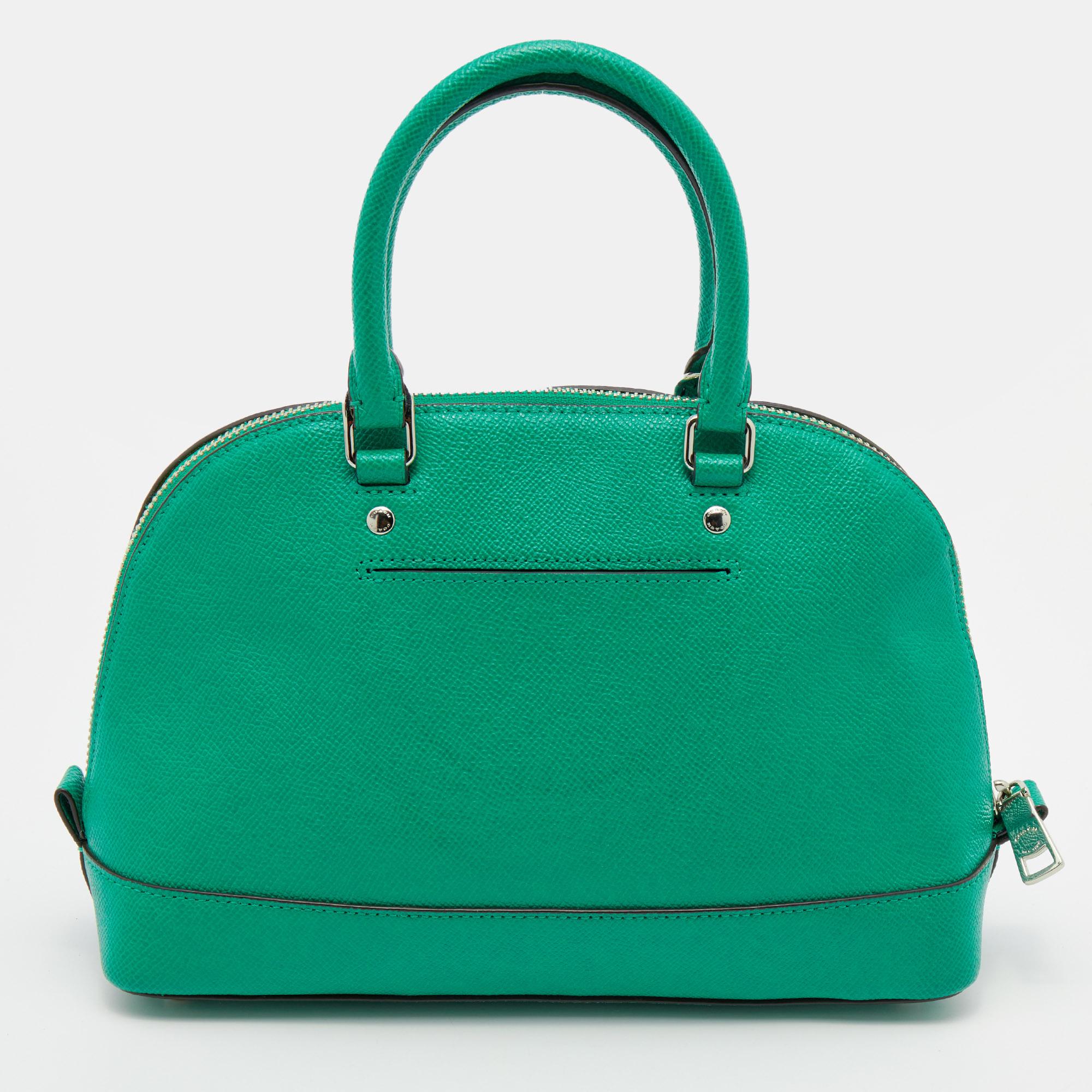 With a bag as vibrant and chic as this Sierra satchel from Coach, you are sure to make a lasting impression! The green bag is crafted from leather and features dual top handles, a detachable shoulder strap, protective metal feet, and a top zip