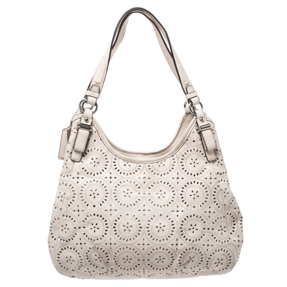 The pretty ivory-hued bag will effortlessly complement all your outfits. Get your hands on this beautiful leather tote to nail a picture-perfect look. It is from Coach and it is designed with laser cut design all over, two top handles, and a