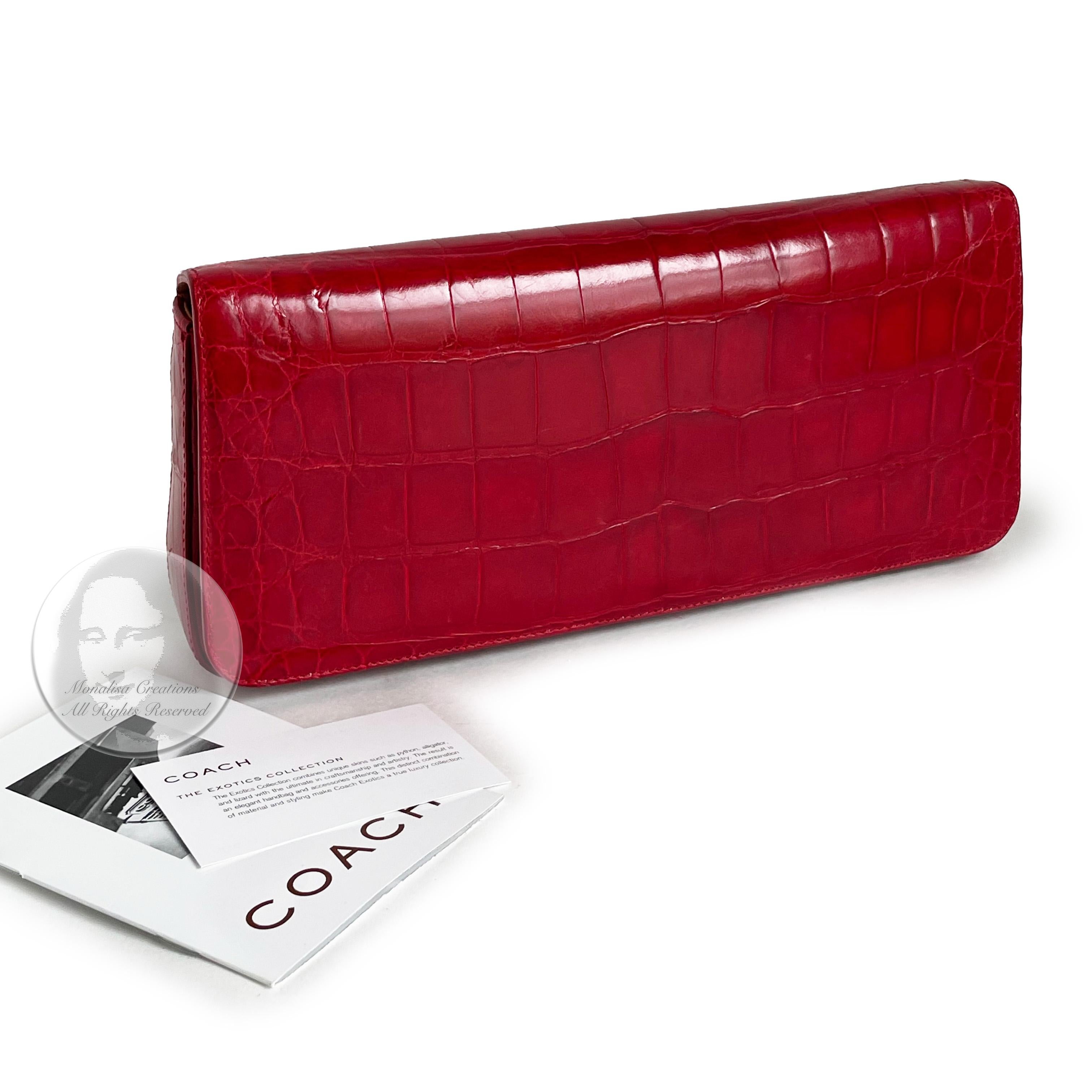 Authentic, preowned Limited Edition Coach Alligator clutch or wristlet bag, from the 2001 Exotic Collection. 

Made from a brilliant glossy red genuine alligator skin, it features a small card slip pocket under the flap and is lined in vachetta &