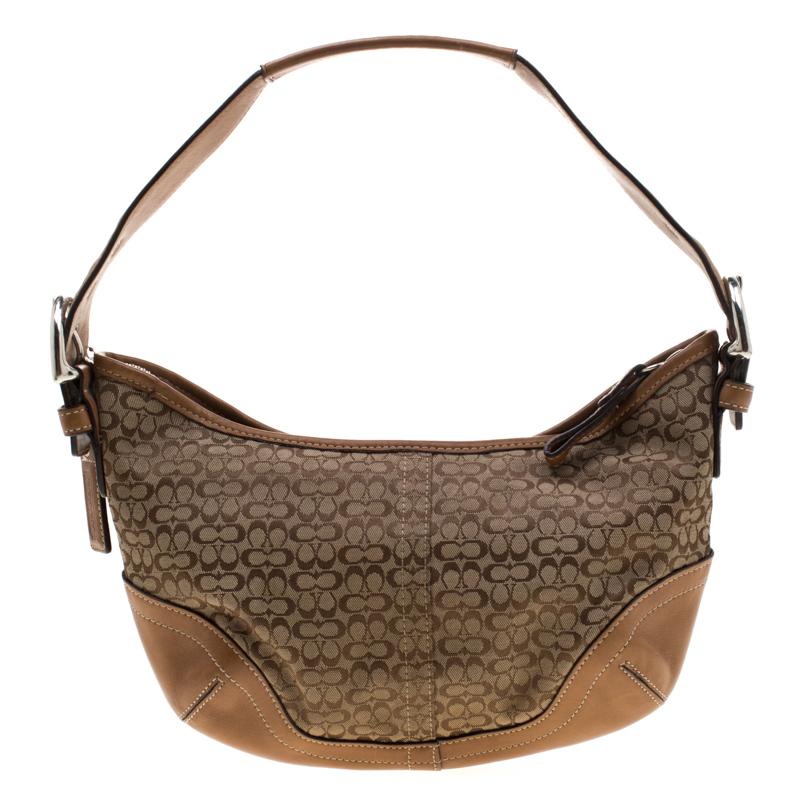 This shoulder bag from Coach is crafted from signature canvas and enhanced with leather. The top zip closure leads to a fabric interior that houses a zip pocket. This petite bag is complete with a wide strap that will comfortably sit on your
